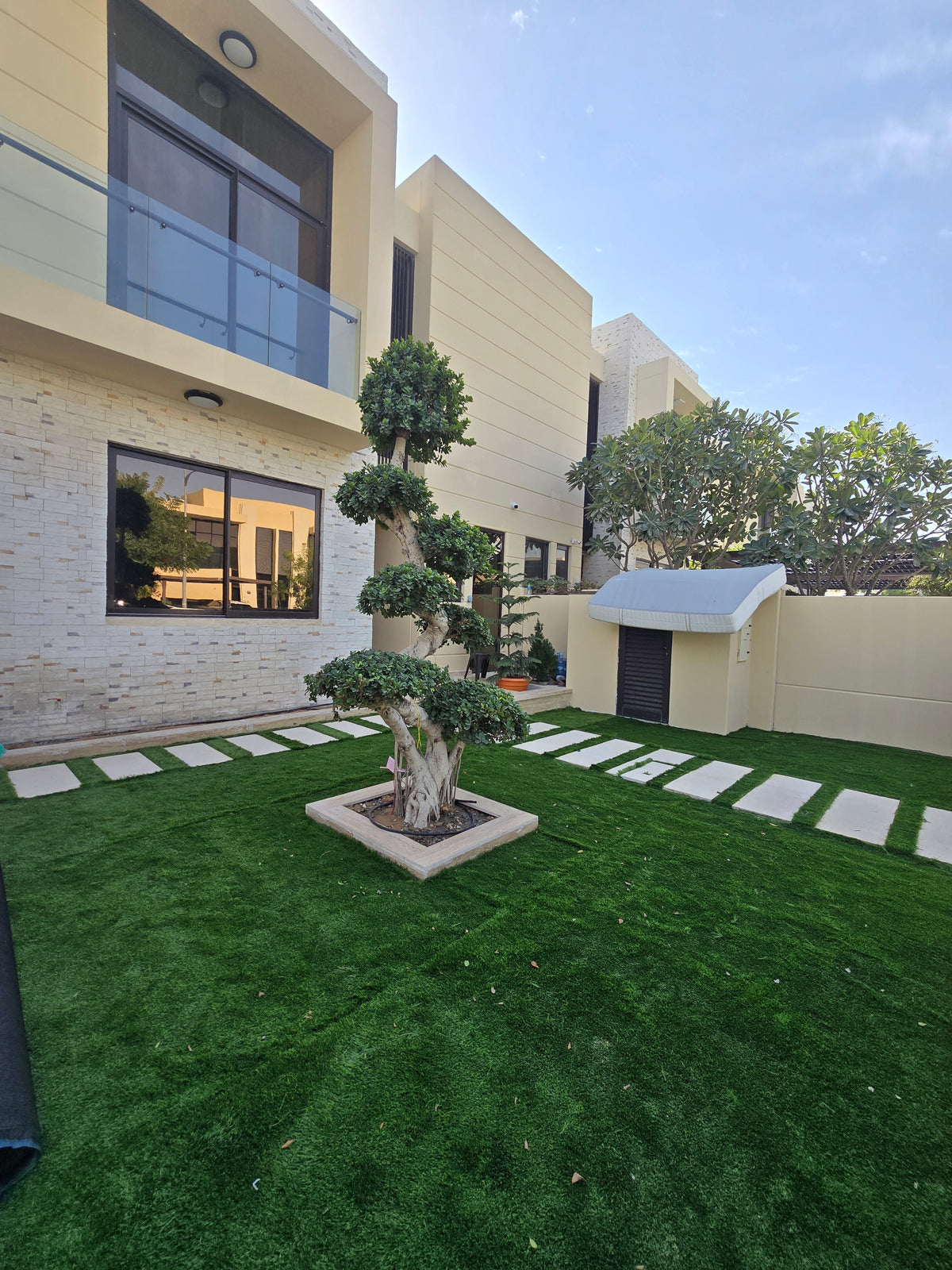 Modern house exterior with green lawn and trees