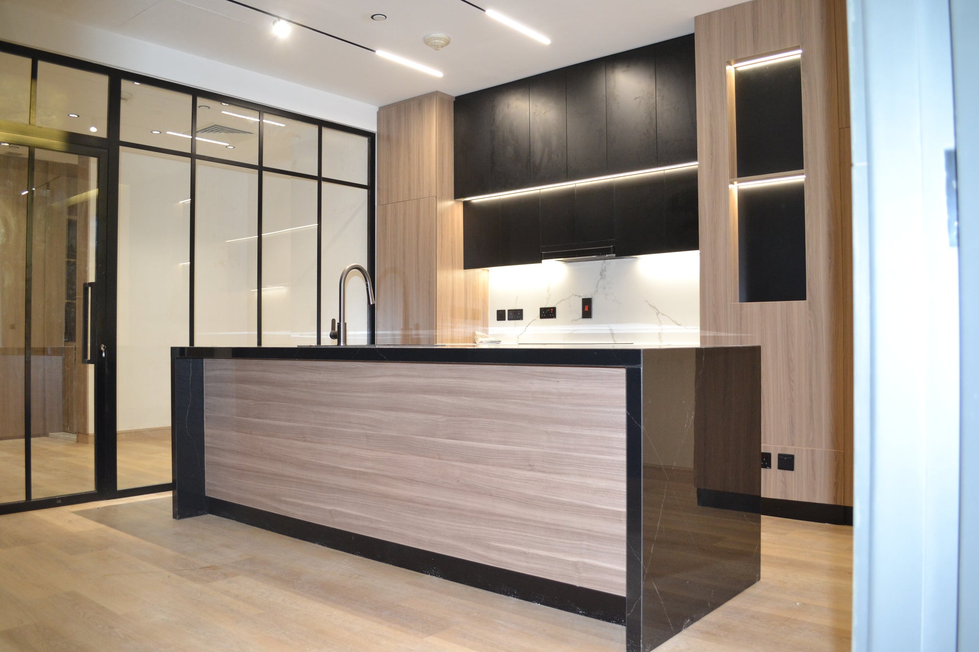 Modern kitchen with wooden island and black cabinets