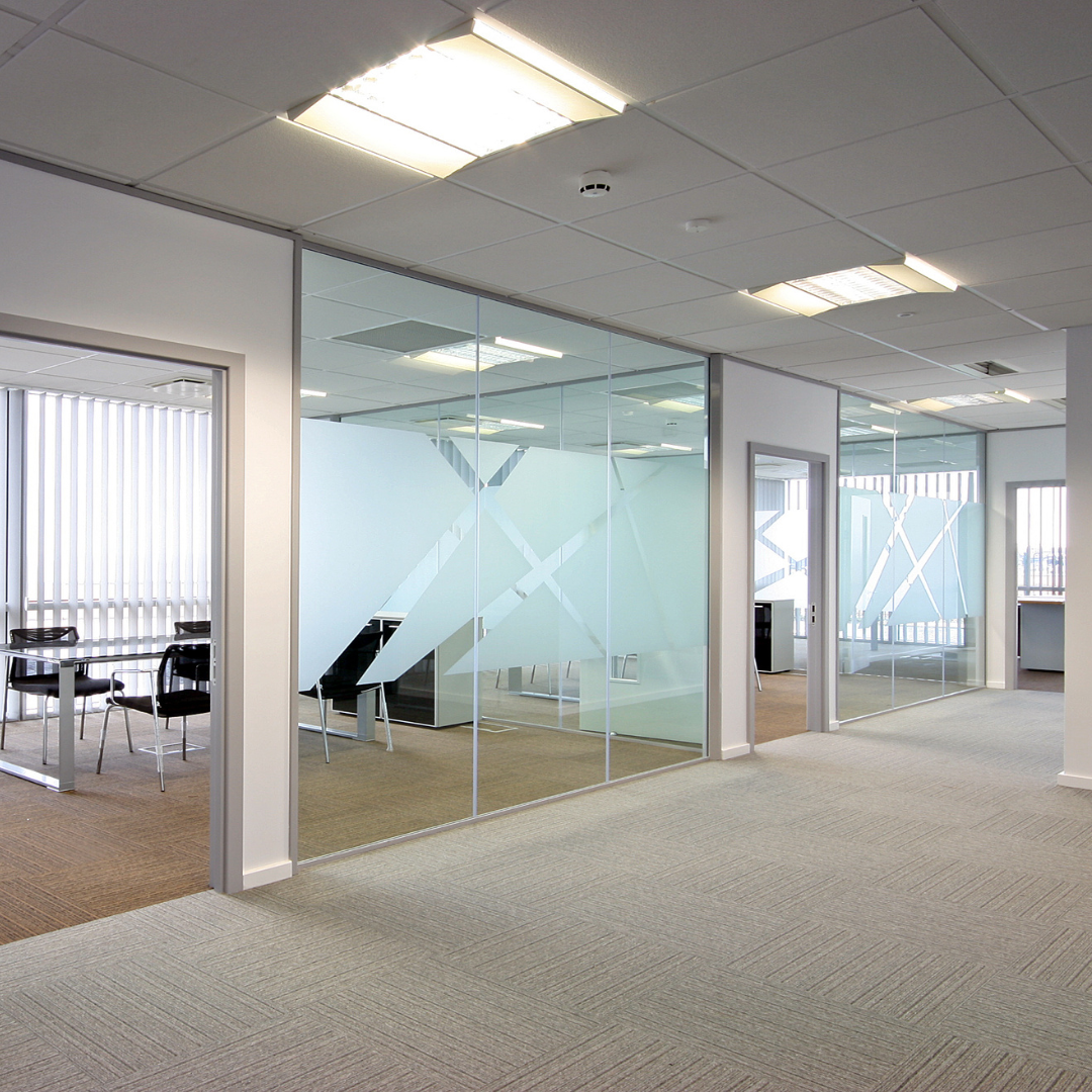 Modern office interior with glass walls and carpeted floors