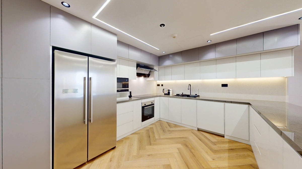 Modern kitchen with stainless steel appliances wooden cabinets and wooden flooring