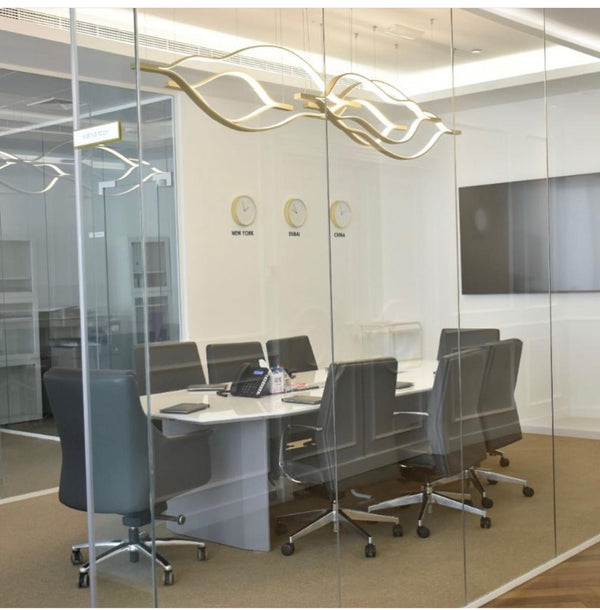 Modern conference room with glass walls, table, and chairs.
