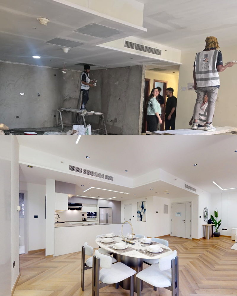 Modern kitchen with dining area, people working on renovation, and a completed room.