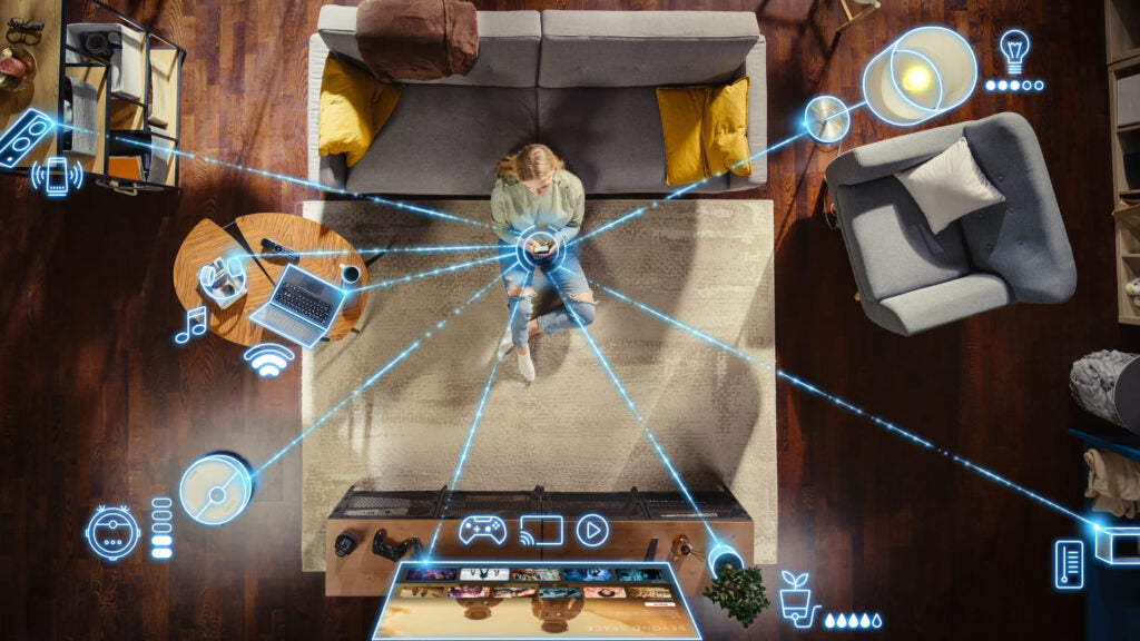 Top-down view of a living room with futuristic interface elements overlaying the scene.