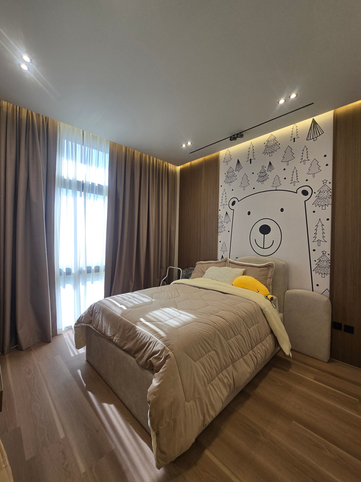 Small room with a bed, wall decorations, and a window.