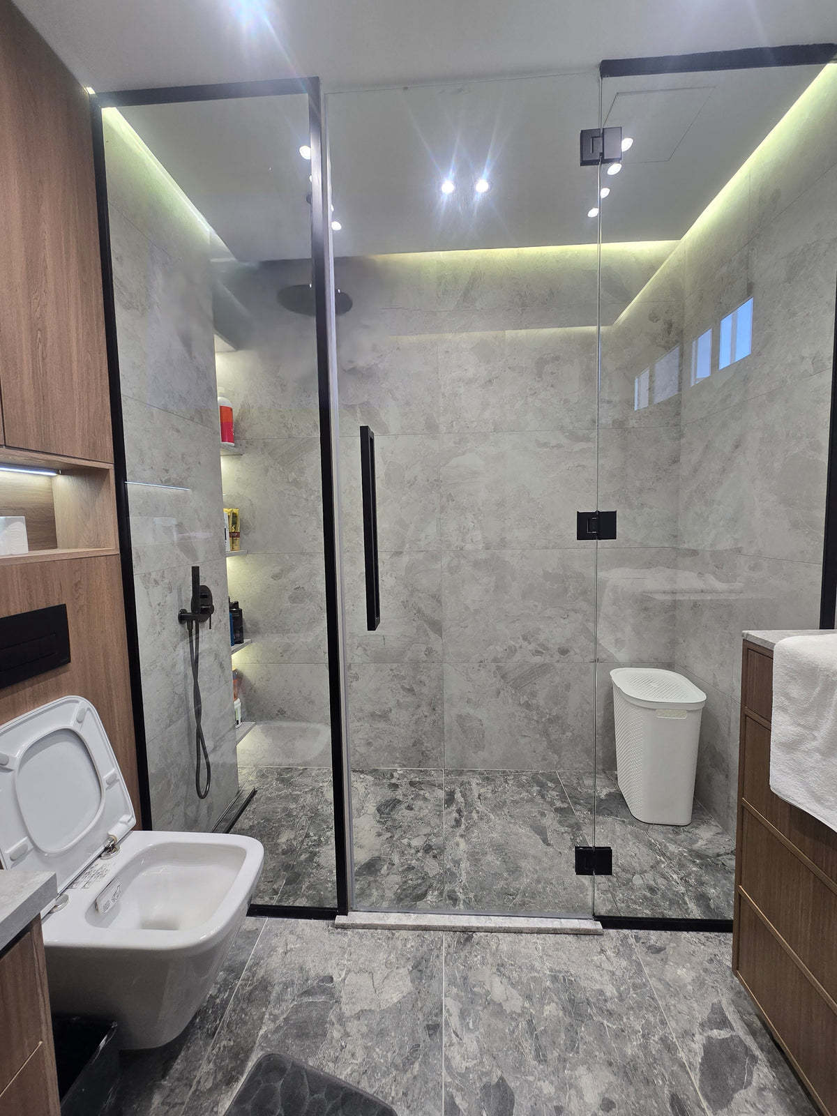 Modern bathroom interior with a toilet and vanity area.