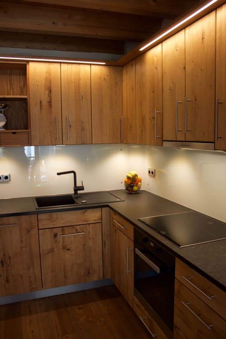 Modern kitchen with wooden cabinets and black countertops