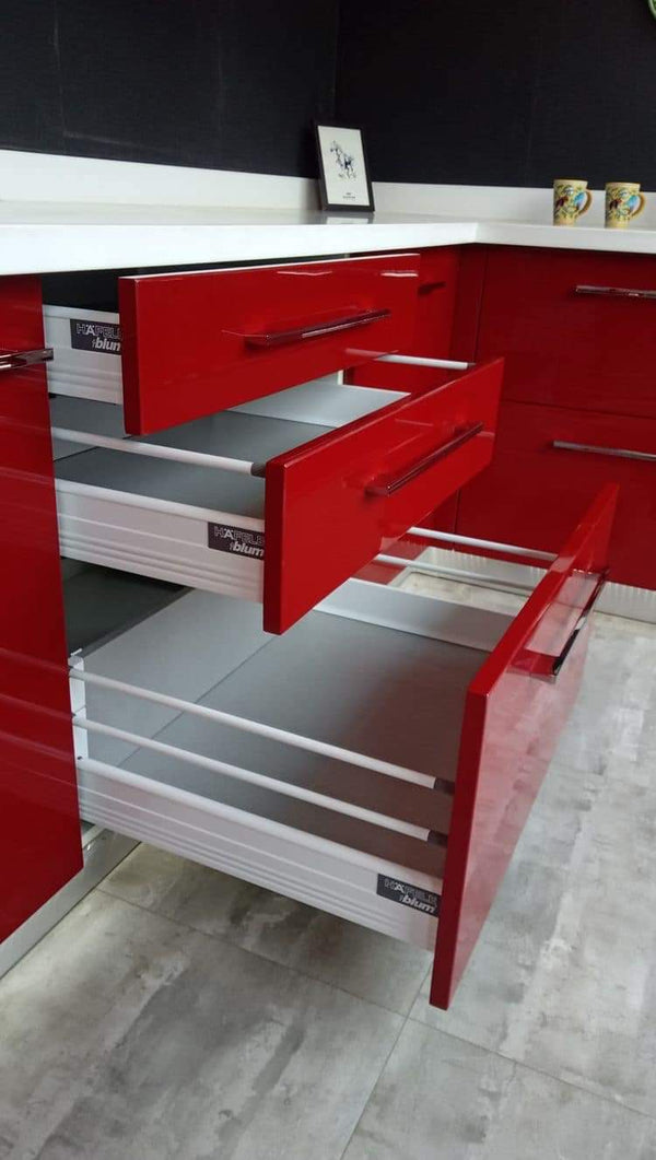 Red tool chest with open drawers on a gray floor.